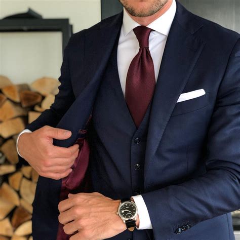 blue suit with burgundy tie.